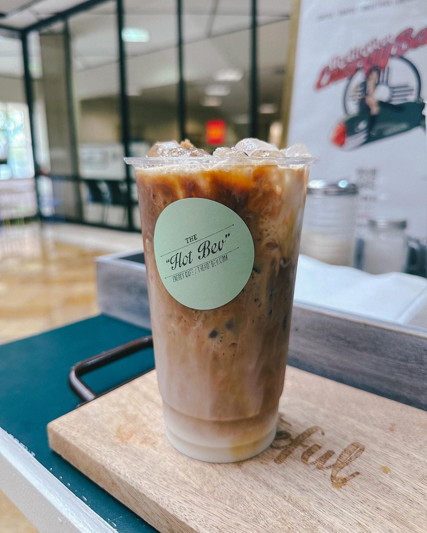 Iced Hot Bev coffee with layered cream in a branded cup