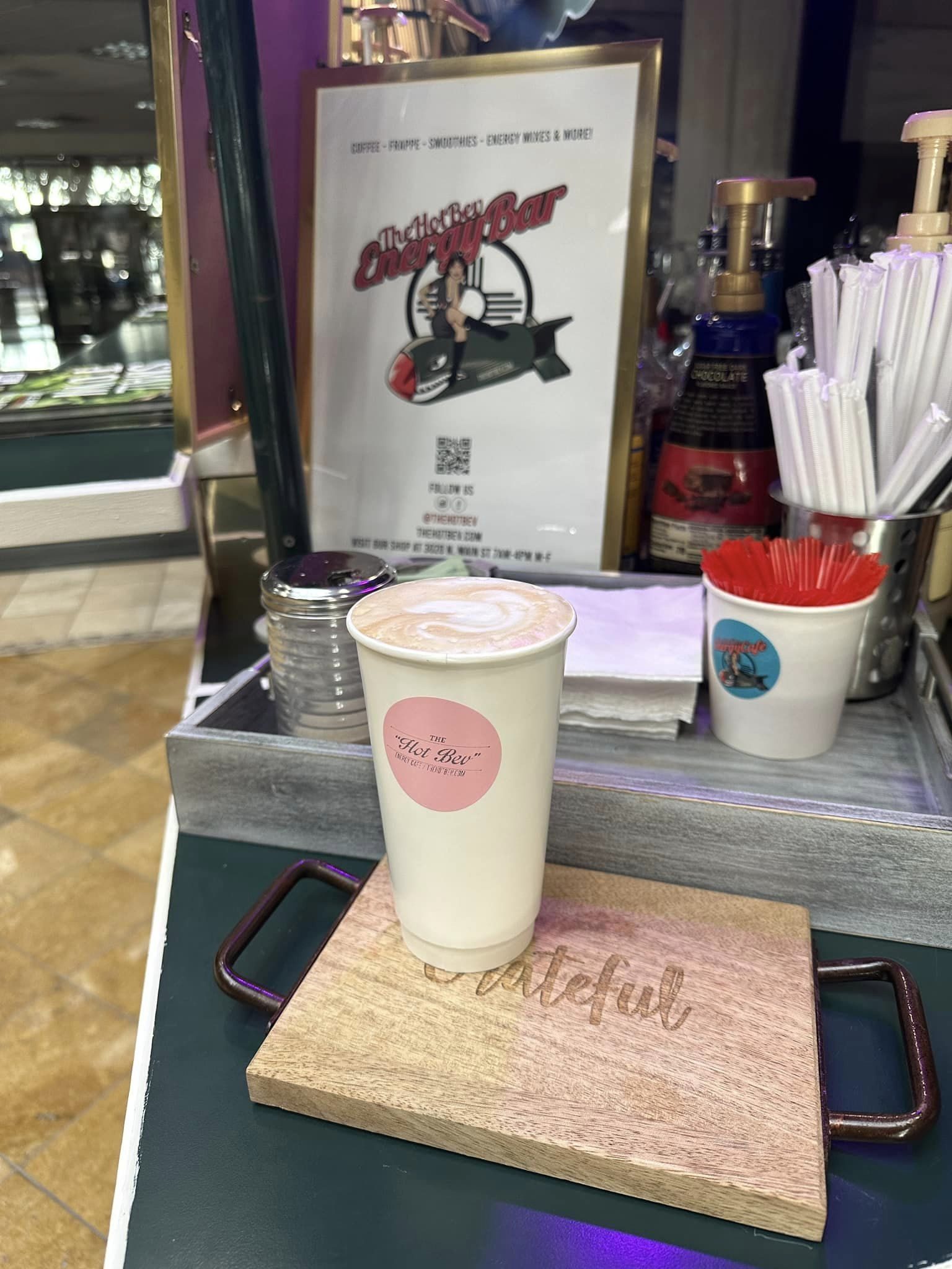 A hot latte with poured foam art on the Hot Bev cart counter